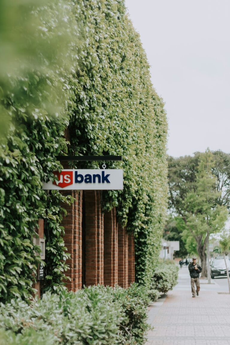 A us bank building is covered in vines.